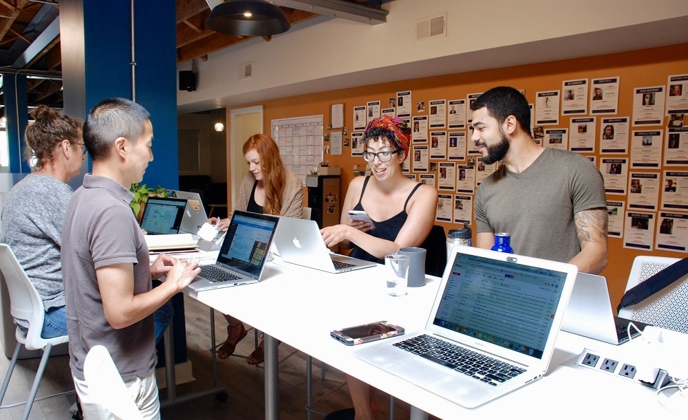 happy team members working together at second shift co-working space