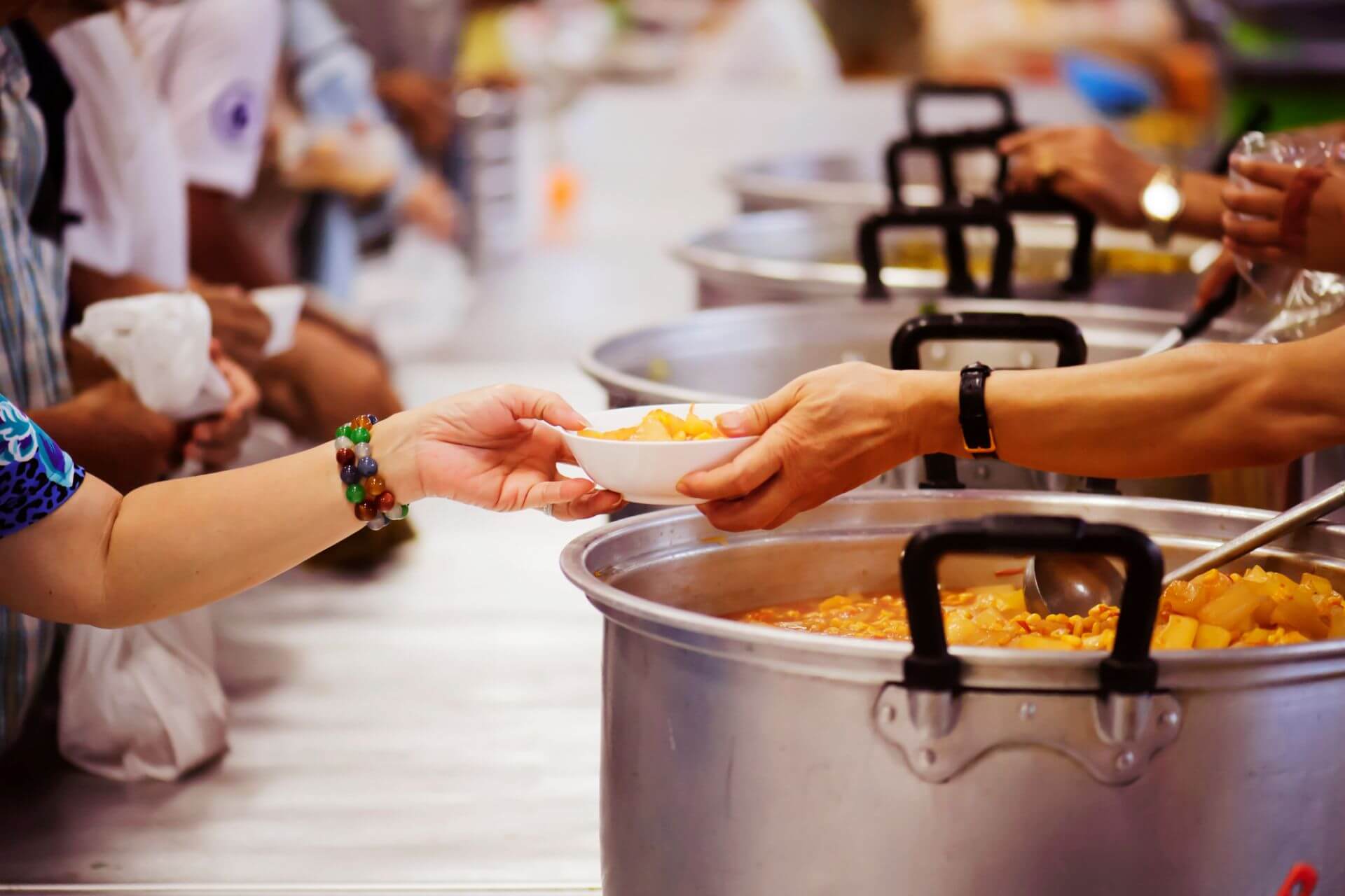 Volunteers in NYC serving food at a soup kitchen