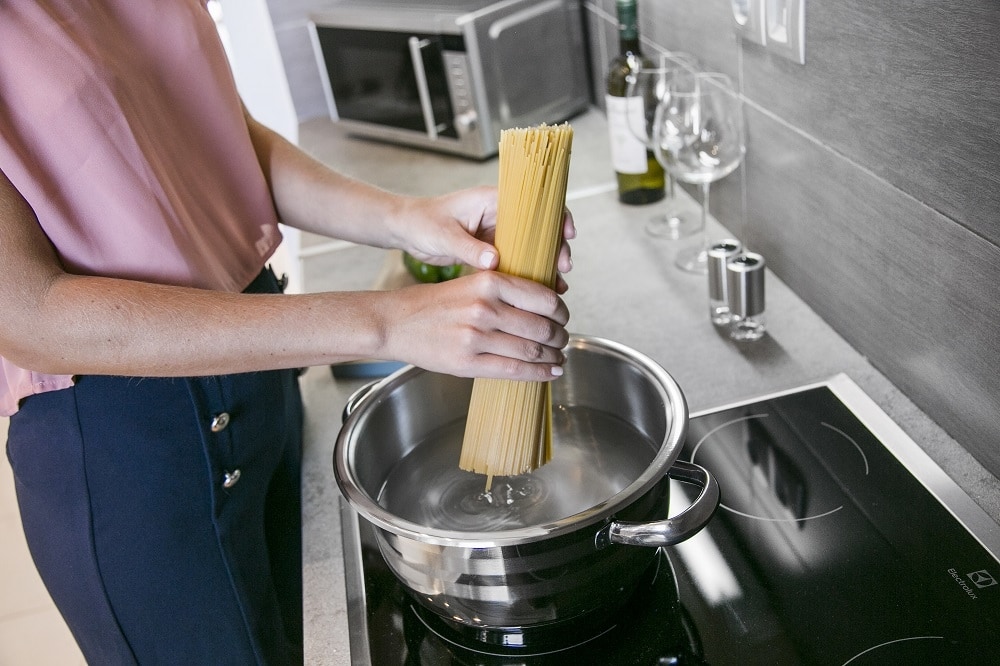 a girl making pasta at home