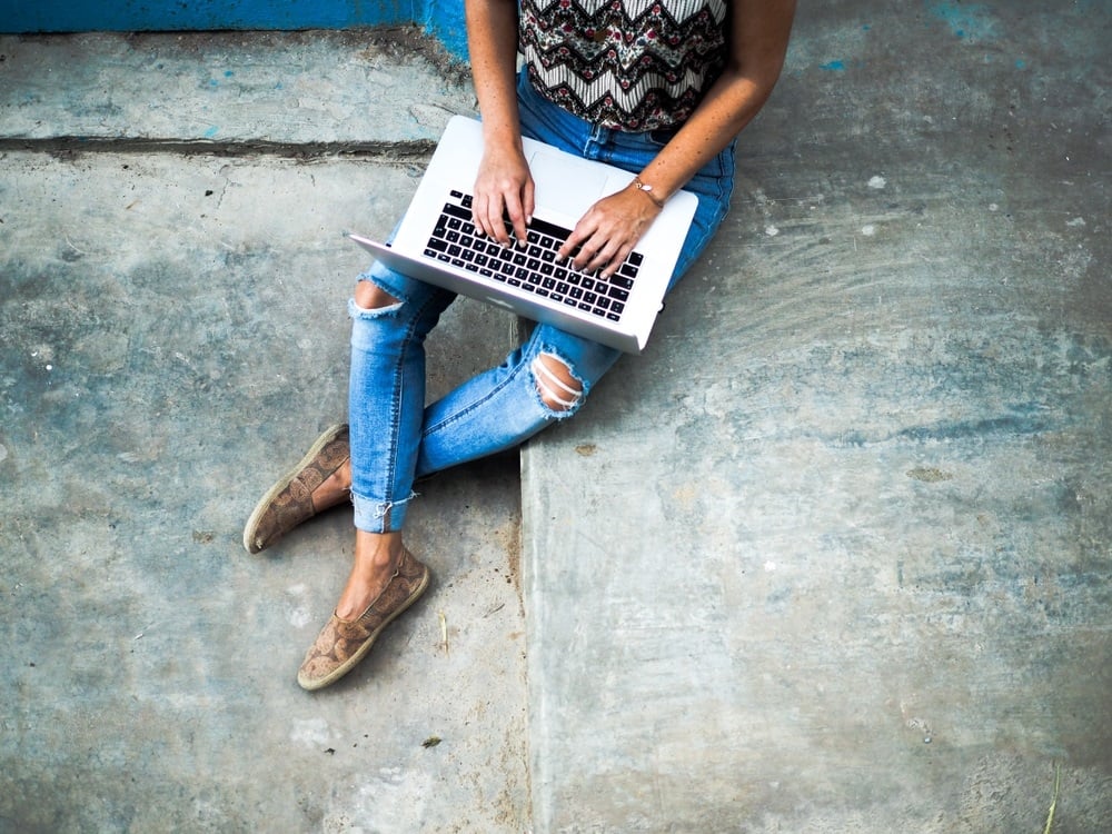 blueprint myths female digital nomad working on a laptop