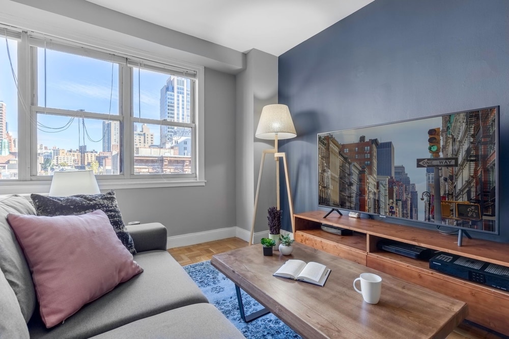 upper east side furnished apartment's living room with Smart TV and skyline view