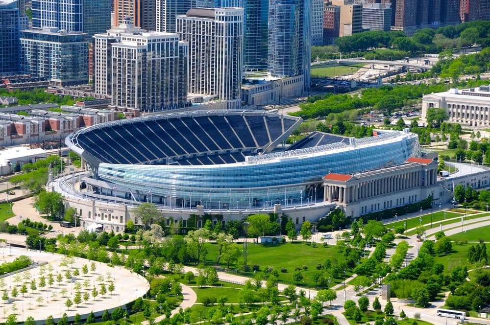 Soldier stadium in Chicago surrounded by green trees with the city buildings in the background