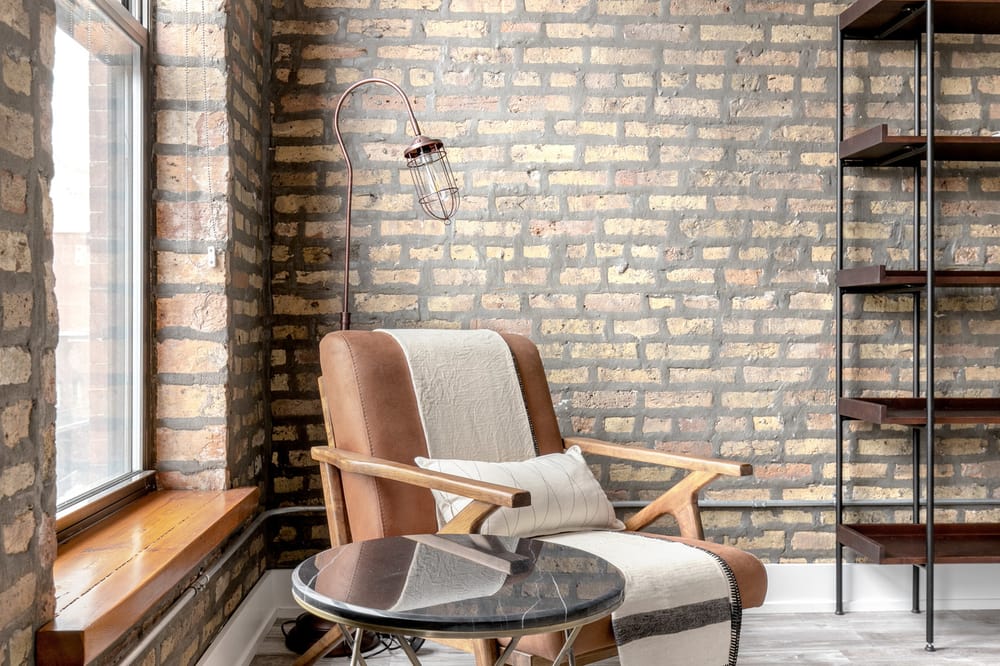 mid century modern lounge chair with exposed brick