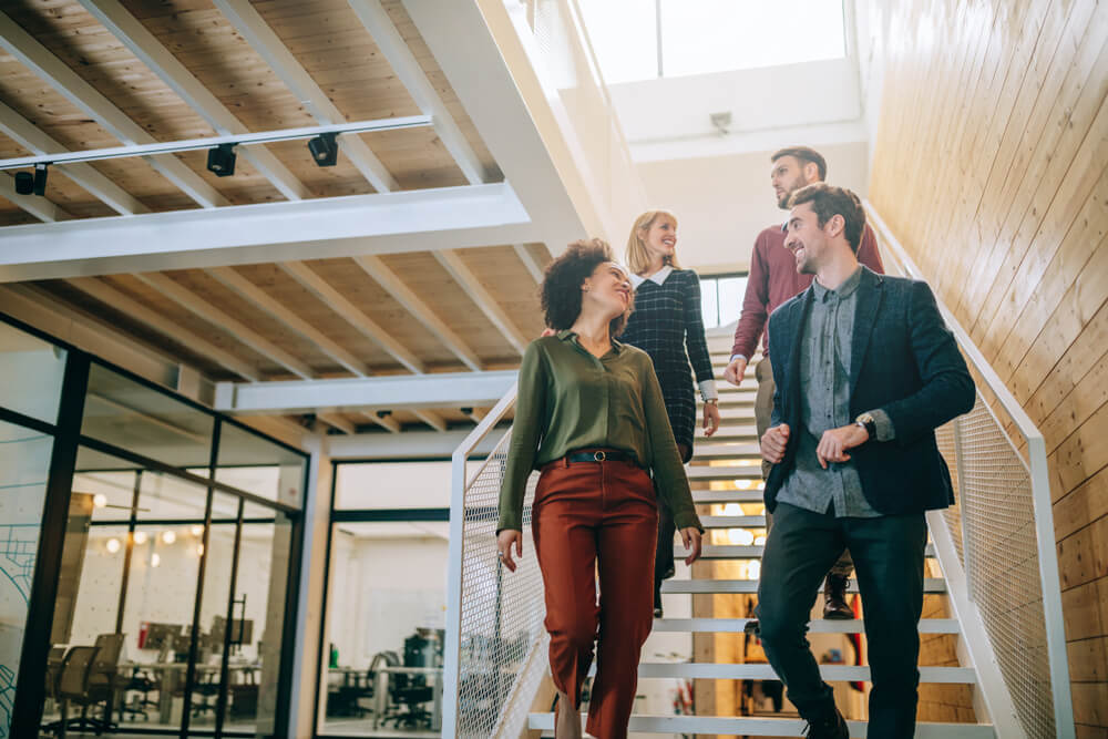 group of colleagues walking down the stairs in a coworking space in Los Angeles