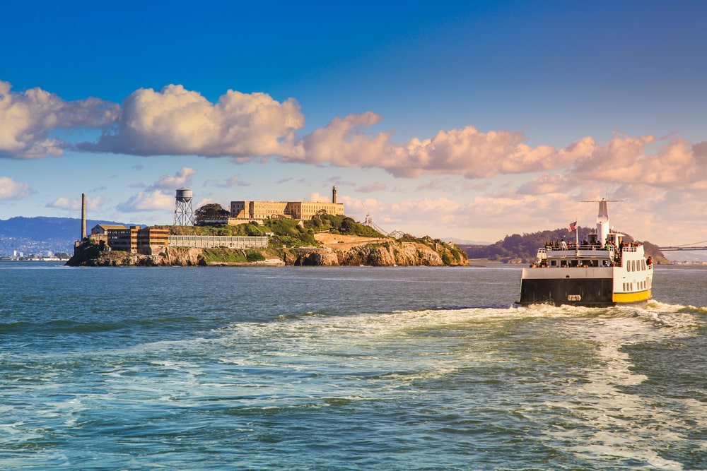 San Francisco apps ferry is taking passengers across the bay and passing by alcatraz island
