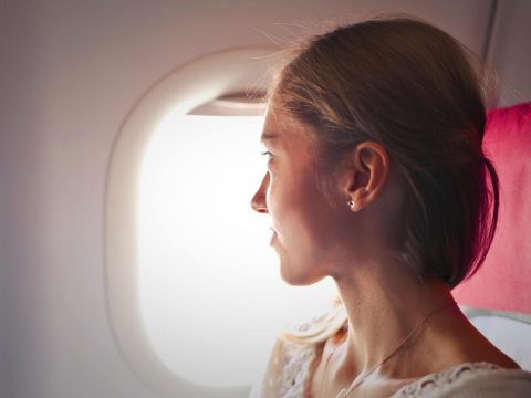 how to avoid jetlag woman plane window
