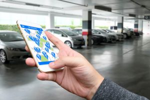 person holding a smartphone using a car-share app