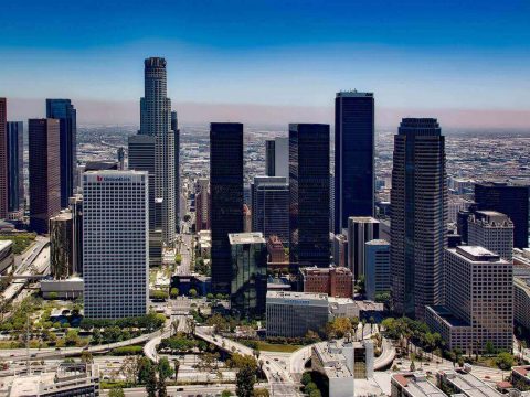 public transport in los angeles birds eye view of downtown LA with the city streets, highways and buildings