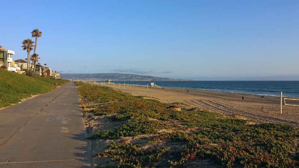 a paved bicycle path that runs along the Pacific Ocean shoreline in Los Angeles