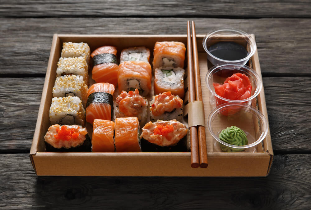 food delivery NYC box of sushi with chop sticks 