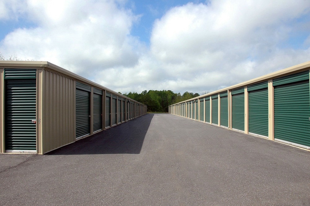  a long row of storage units with green doors