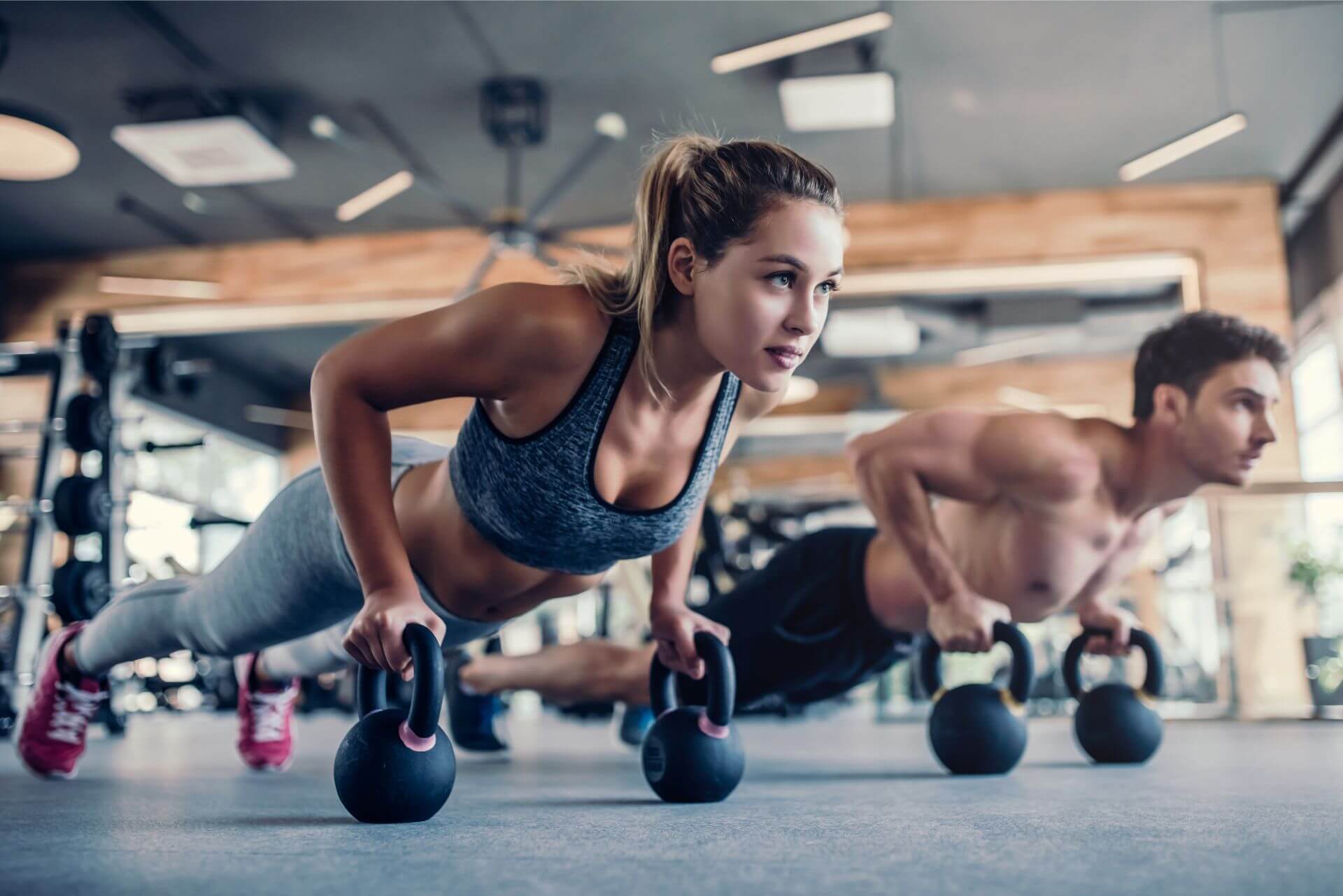 gyms boston couple working out in the gym with kettle bells