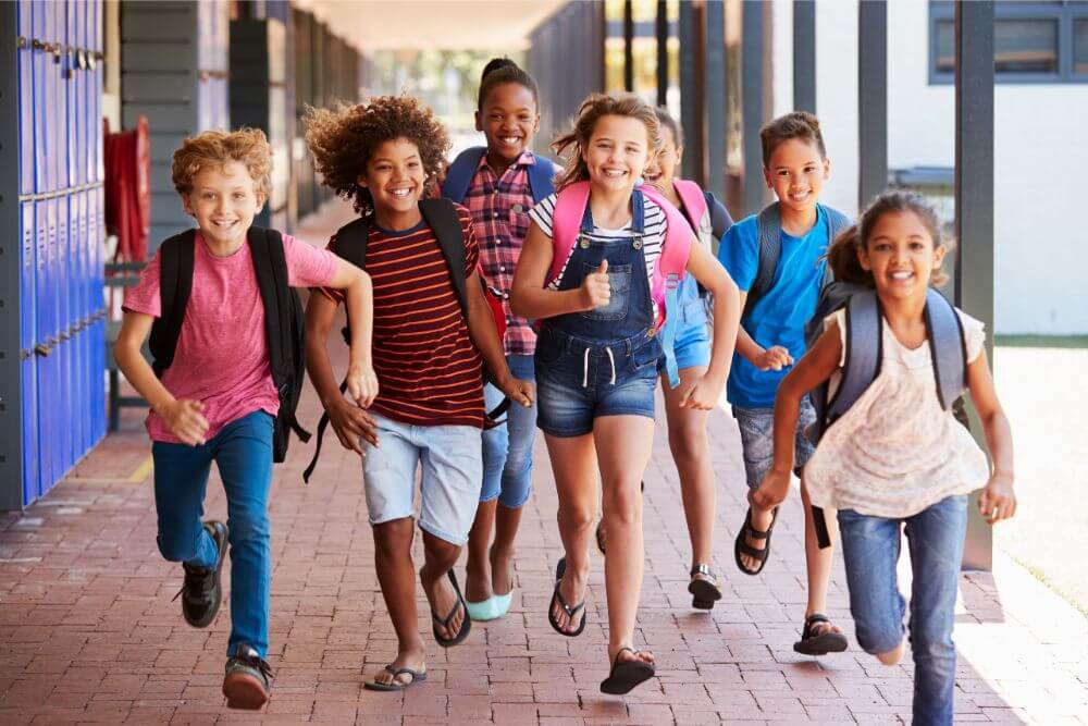 children happily running at school