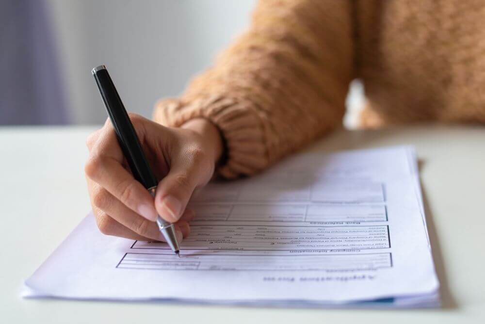 a person, filling out an application form 