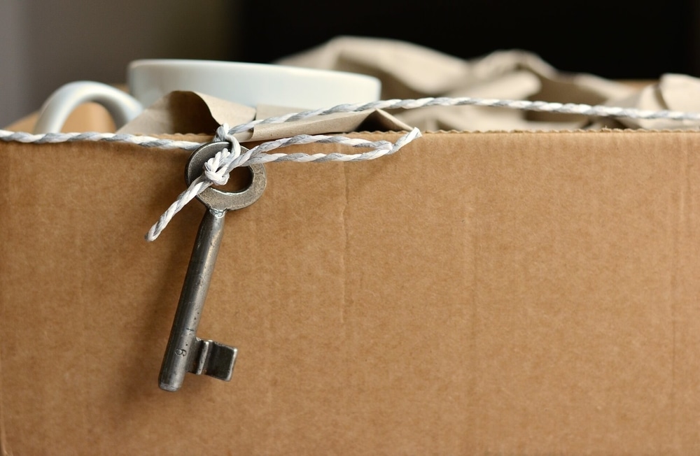 a cardboard box full of items inside and an old key at the top