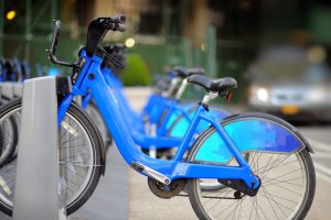 bird scooter in Boston bluebikes side by side while locked in place at bike station