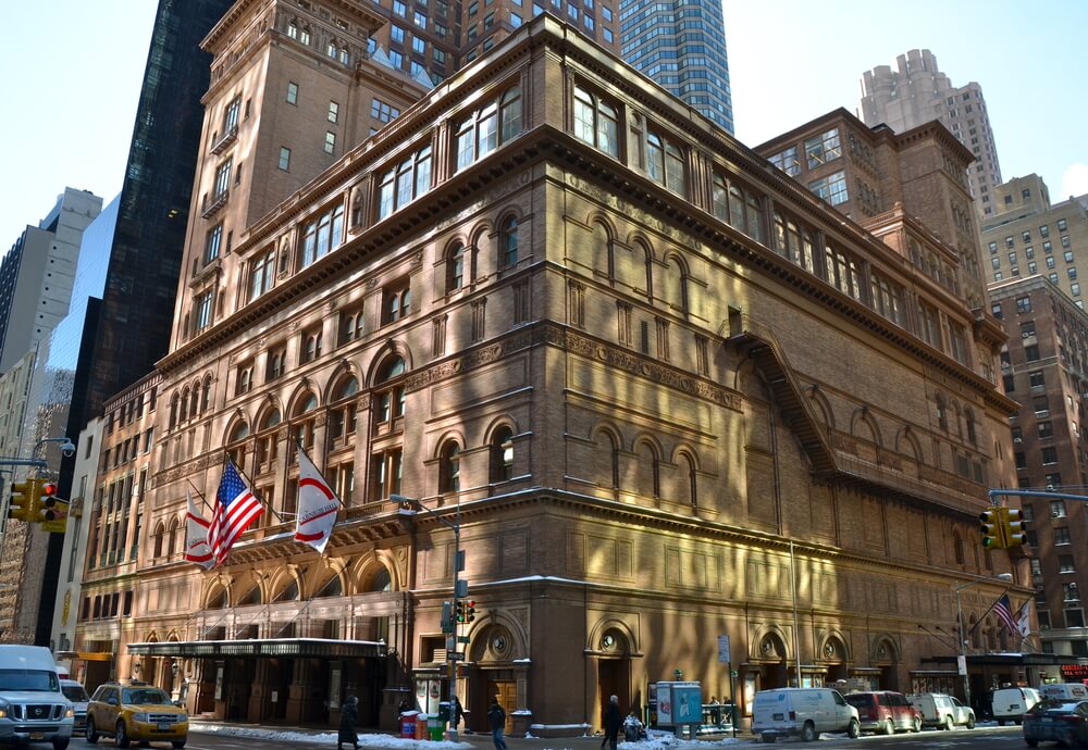 Carnegie Hall in New York City. It's a large building on the corner of the block with flags hanging over the front entrance