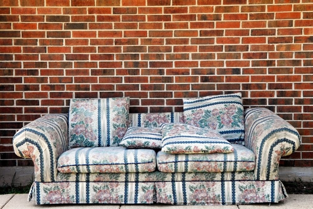 Sofa in front of a brick wall