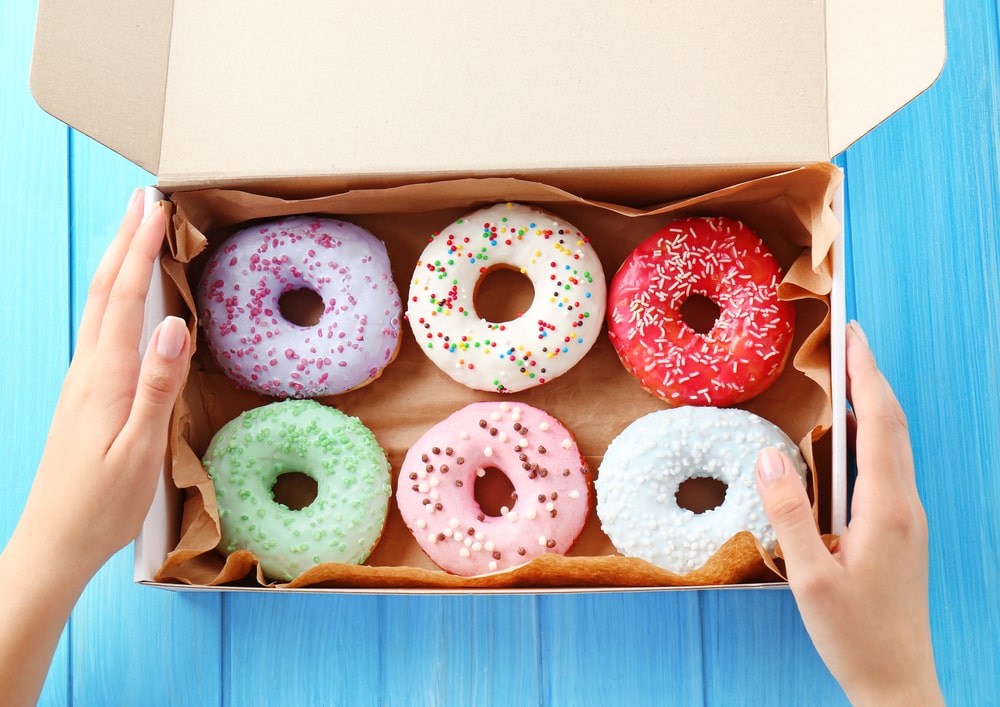 Box of donuts with colourful icing 