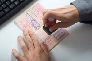 a person putting a stamp on a passport