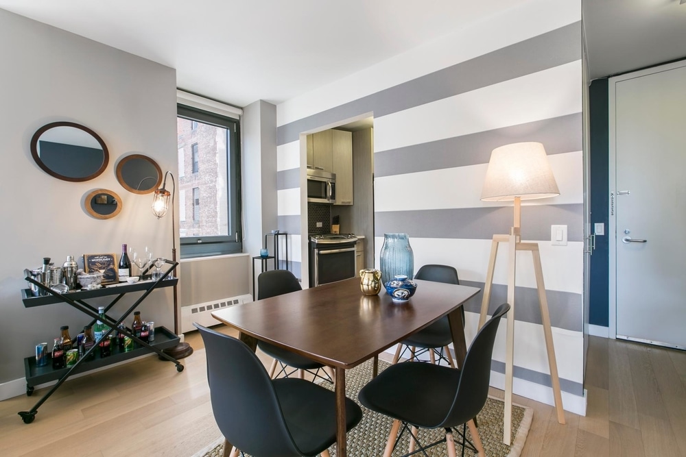 studio apartment NYC dining room with drink cart and mirrors