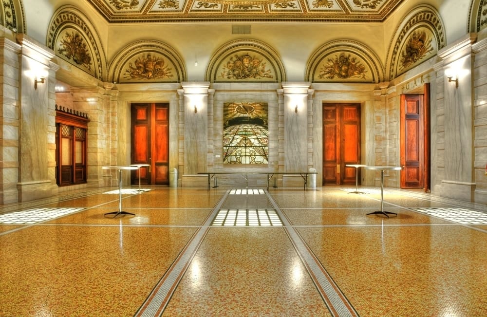 a look at the large golden and marble interior of the chicago culture center