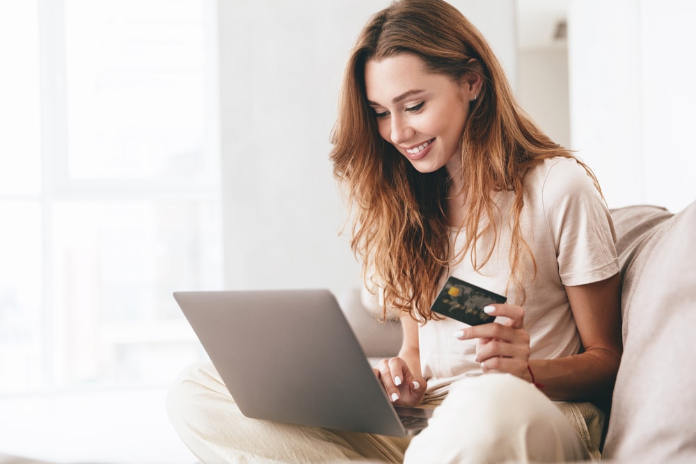 young woman buying thing online with her credit card