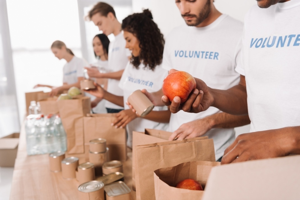 volunteers packing food into paper bags