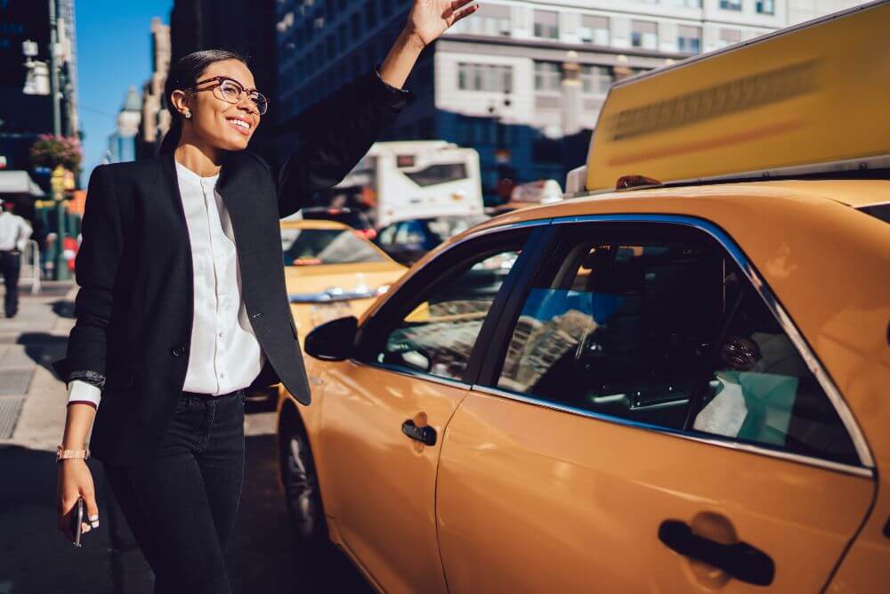 a woman hailing a yellow cab