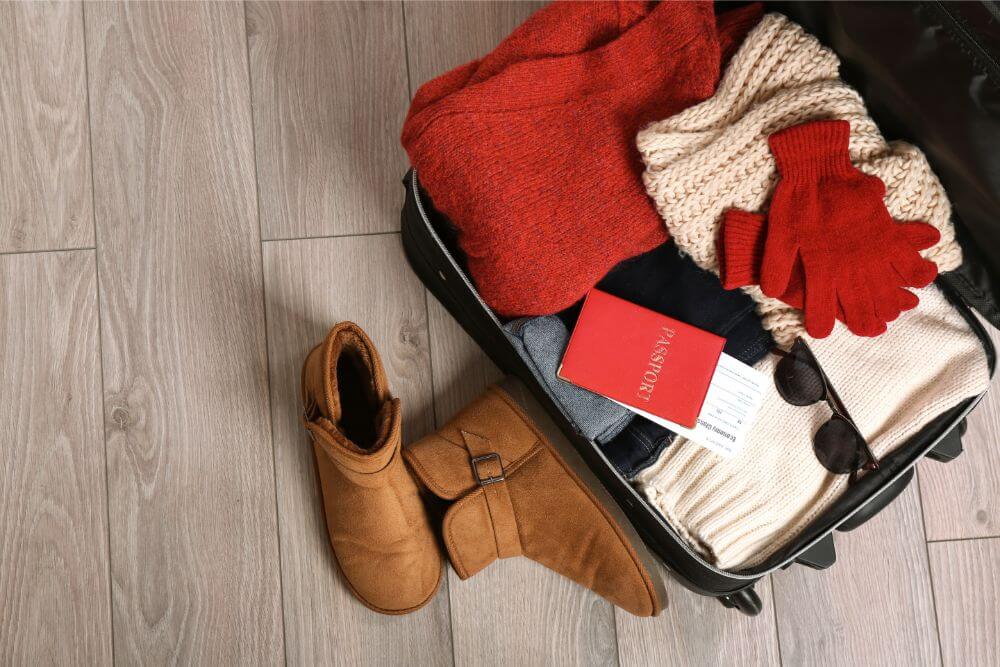 a suitcase packed with winter clothes