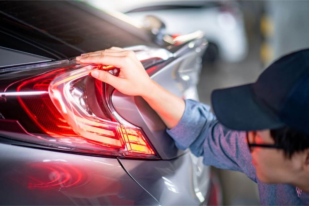 a man carefully inspecting a car