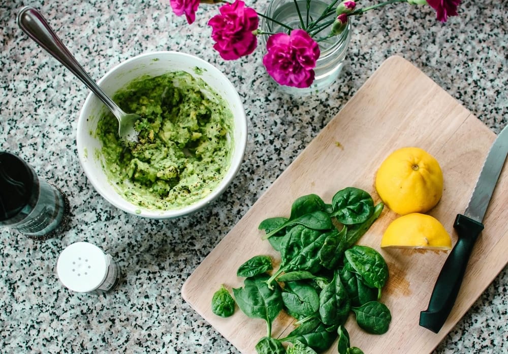 a kitchen counter with a bowl of homemade pesto 