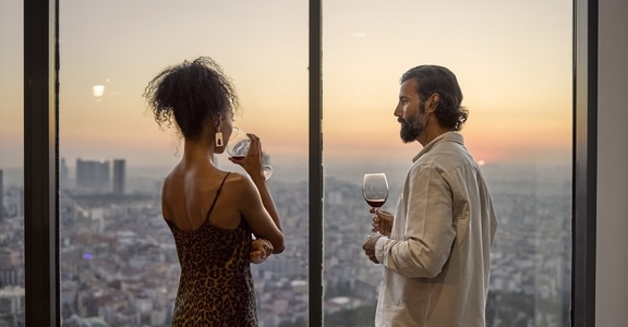 attractive couple drinking wine at sunset