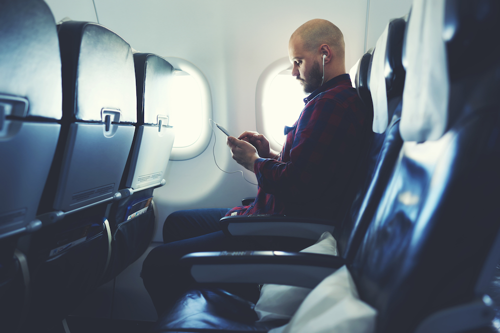 a man on a flight reads a book