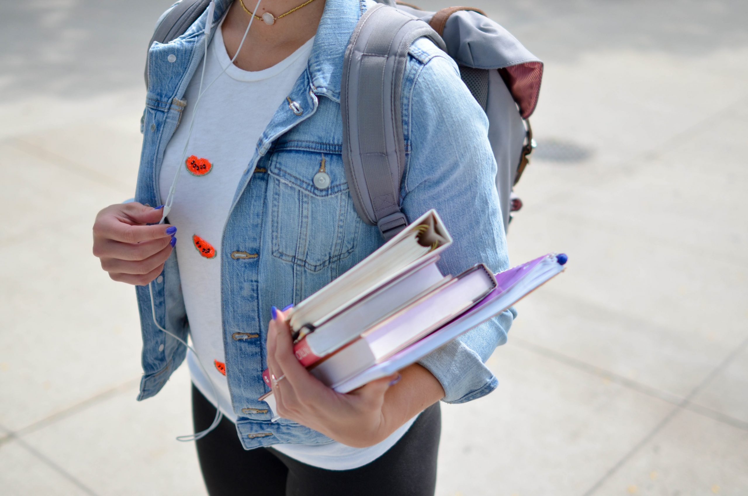 Girl with backpack and books