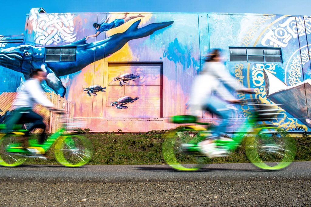 Biking in front of mural