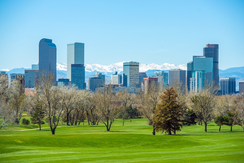 Green park with the city of Denver in the background