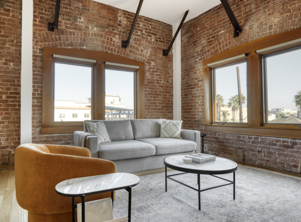 Exposed brick living room in Los Angeles apartment
