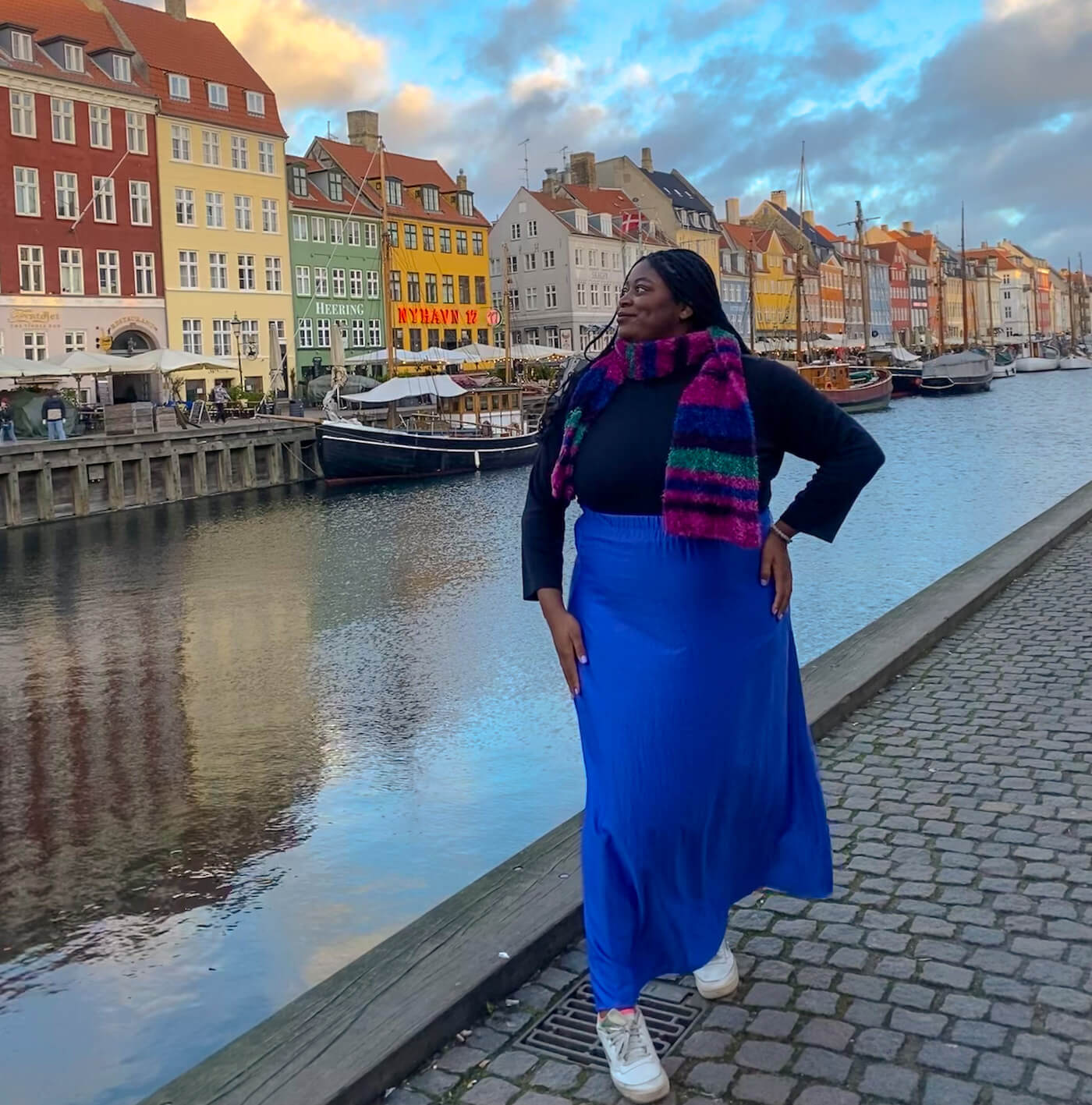 Abigail in front of a river in Copenhagen